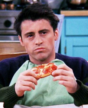 A picture of Joey Tribbiani eating pizza while deep in thought
